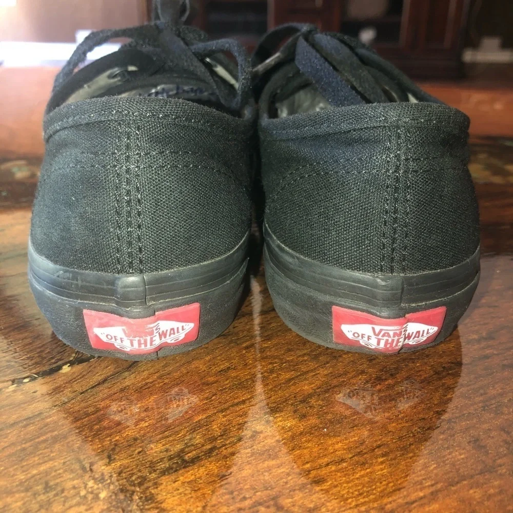 Vans all black kids lace up skateboard shoes.